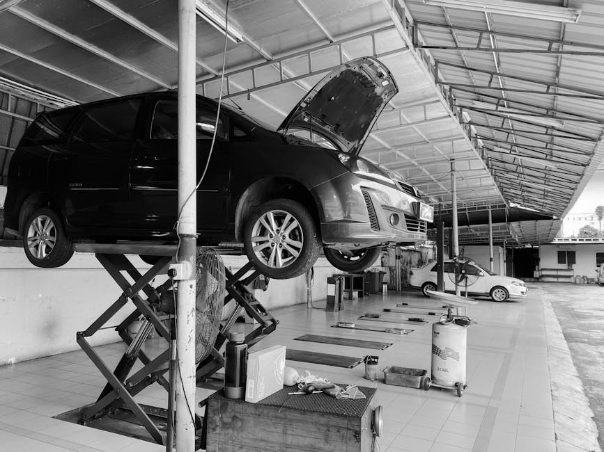 A black and white photo of a vehicle being serviced in a workshop in Ipoh, Malaysia.